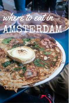 there is a plate with food on it and the words where to eat in amsterdam