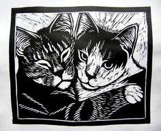 two cats sitting next to each other on top of a white sheet with black ink