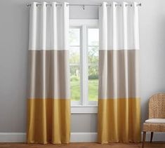 the curtains in this room are yellow and white