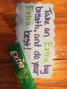 a piece of paper sitting on top of a wooden table next to a tube of toothpaste