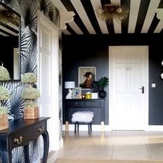 a black and white striped room with a vanity