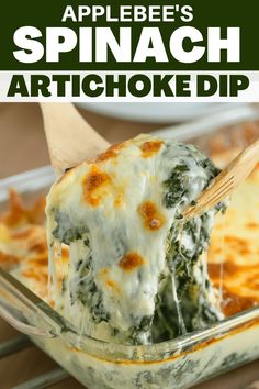 spinach artichoke dip in a casserole dish with a wooden spoon