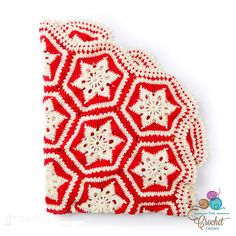 a red and white crocheted doily with snowflakes on it