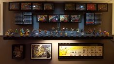 there are many figurines displayed on the wall above the display case in this room