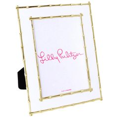 a white and gold frame with pink lettering on it