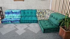 a green couch sitting on top of a carpet covered floor