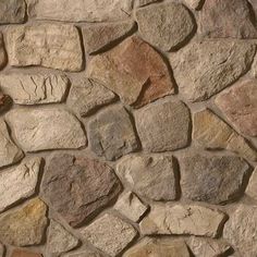 a stone wall that looks like it has been made out of different types of rocks