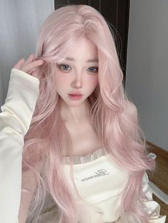 a woman with long pink hair is posing for the camera