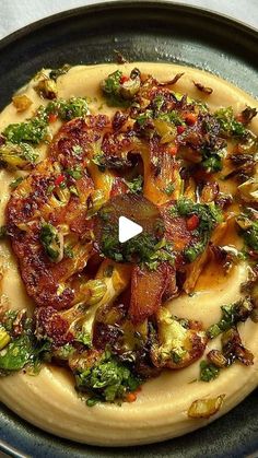 a pizza topped with broccoli and other toppings on top of a pan