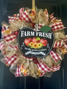 a farm fresh wreath hanging on the front door