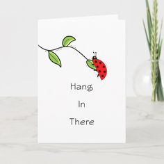 a card that says hang in there with a ladybug sitting on a branch