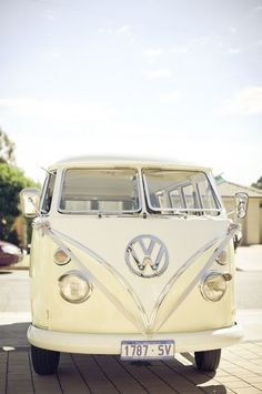 an old vw bus is parked on the street