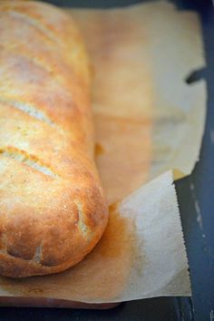 a loaf of bread sitting on top of a piece of wax paper