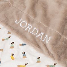 the name jordan is written on a blanket that has dogs all over it, including an afghan