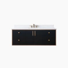 a black and white bathroom vanity with two gold faucets on the sink top