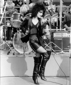 a black and white photo of a woman on stage