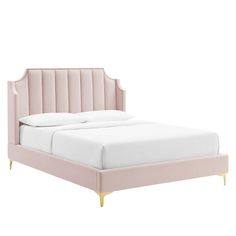 the pink bed frame is made up with gold legs and headboard, along with white sheets