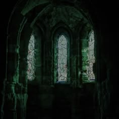 an old church with stained glass windows in the dark