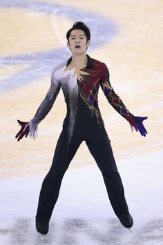 a male figure skating on an ice rink