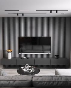 modern living room with black and white striped wallpaper, grey couches, large flat screen tv