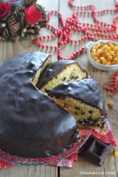 a chocolate covered cake sitting on top of a table next to a bowl of candy