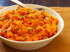 a white bowl filled with mashed sweet potatoes