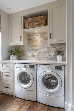 a white washer and dryer in a room with wood flooring on the ground