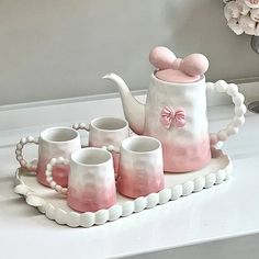 pink and white ceramic tea set on tray