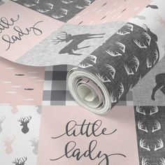 a pink and black wallpaper with deers on it, the words little lady are printed