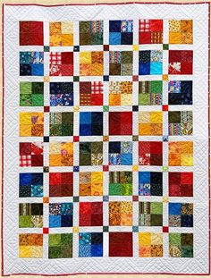 a multicolored quilt with squares on the top and bottom, all in different colors