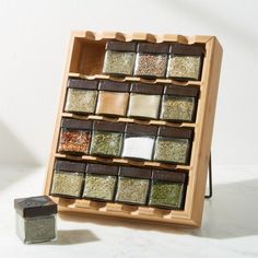 a wooden spice rack filled with lots of different kinds of spices