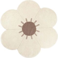 a white flower rug with brown center