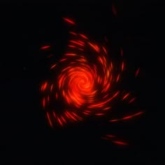 an image of a red spiral in the dark