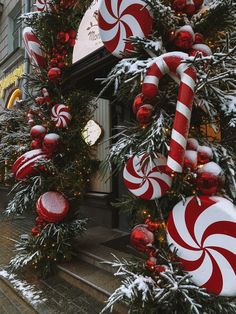 christmas decorations and candy canes are on display in front of a store