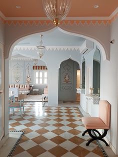 an archway leading to a living room and dining area with checkered tile flooring