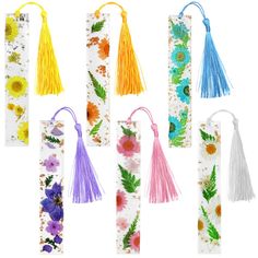 six bookmarks decorated with flowers and tassels