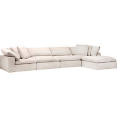 a white sectional couch with pillows on it's back and the seat folded out