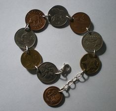 a bracelet with five different types of coins on it