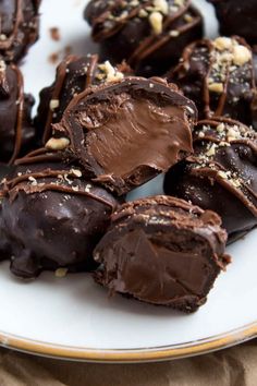 chocolate covered candies on a plate with nuts