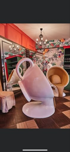 the interior of a furniture store with chairs and vases on display in front of them