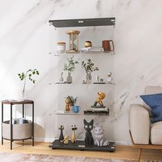 a living room with marble walls and shelves filled with figurines on top of them