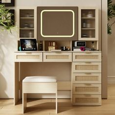 a desk with drawers and a mirror above it in a room that has wooden floors