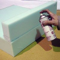 someone is painting the inside of a box with green and white paint, while another person holds a spray bottle