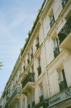 an apartment building with many balconies and flowers on the balconys in paris