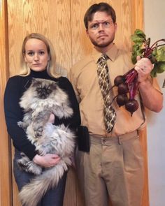 a man and woman standing next to each other in front of a door holding vegetables