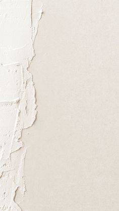 a white wall with peeling paint on it