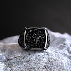 925 Sterling Silver, Targaryen House Dragon, GOT Inspired Signet, Handcrafted Fan Art, Fantasy Lovers' Emblem, Unique Westeros Accessory Product Description (1500 characters): Dive deep into the mythical world of Westeros with our Targaryen House Dragon GOT Inspired Signet ring. Crafted with finesse from 925 sterling silver, this piece encapsulates the fiery essence of House Targaryen, one of the great houses in the beloved fantasy series. The central emblem, showcasing the majestic Targaryen dr Targaryen House, Viking Ring, Masonic Ring, Fantasy Lovers, House Targaryen, Retro Ring, Animal Rings, Art Fantasy, Everyday Rings