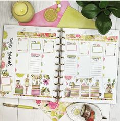 an open planner book sitting on top of a table