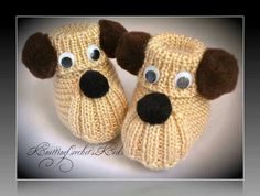 a pair of knitted dog slippers with googly eyes