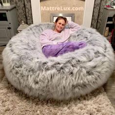 a woman is sitting in a bean bag chair